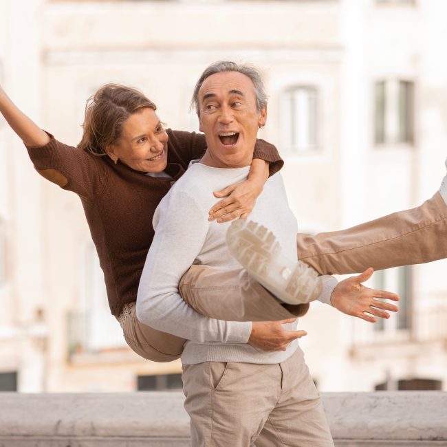 Retired Couple Sharing Fun Travel Moments in Lisbon Posing Outdoors