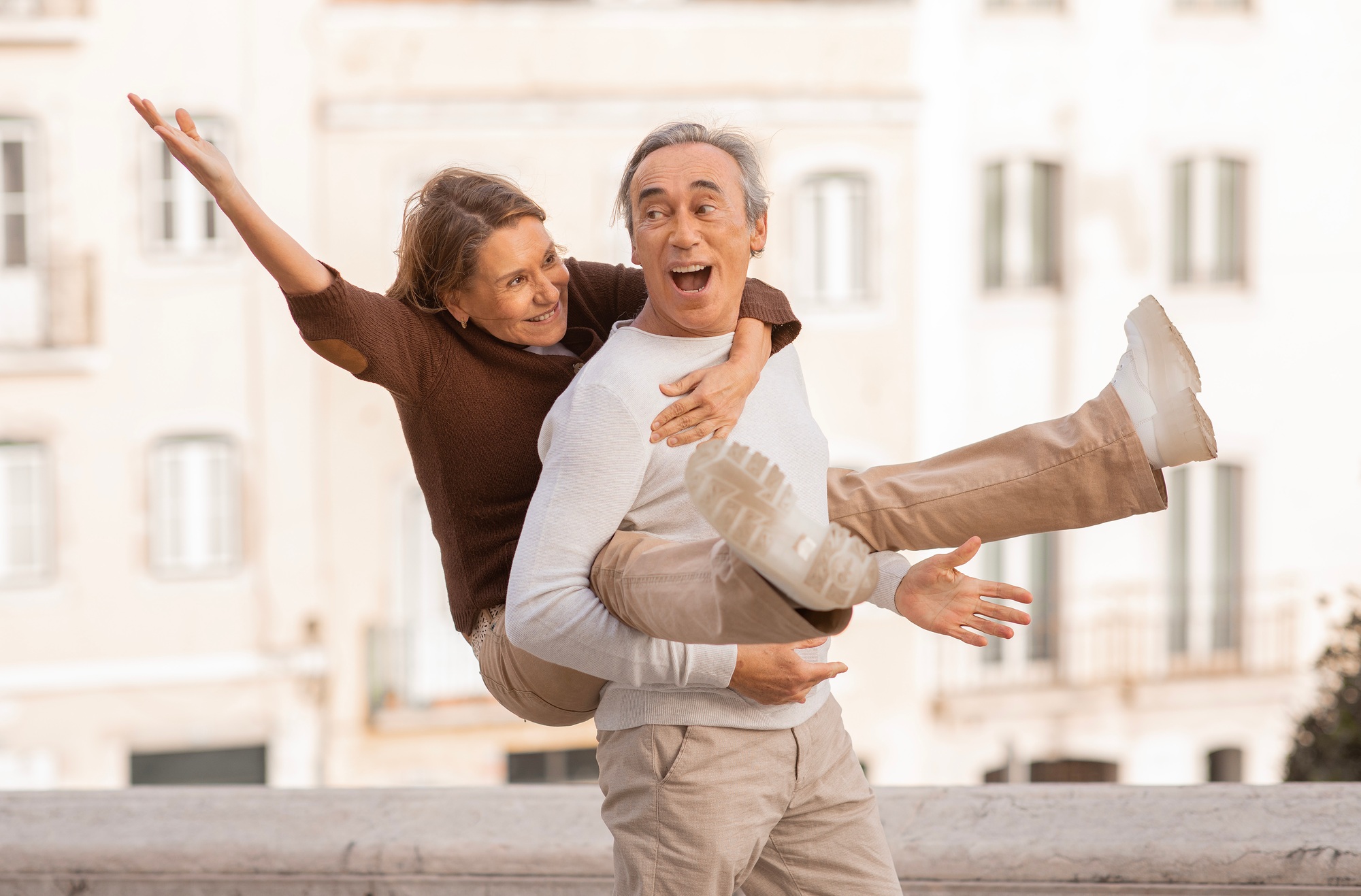 Retired Couple Sharing Fun Travel Moments in Lisbon Posing Outdoors