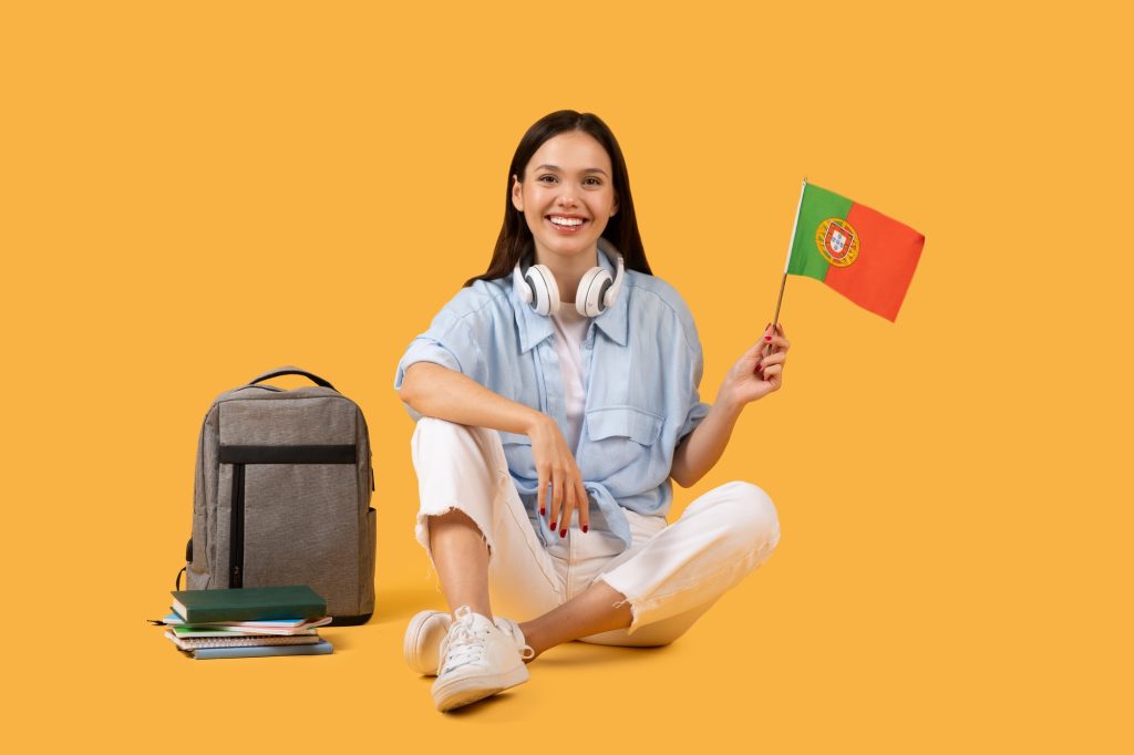 Smiling lady student with headphones and Portuguese flag, ready for cultural study session