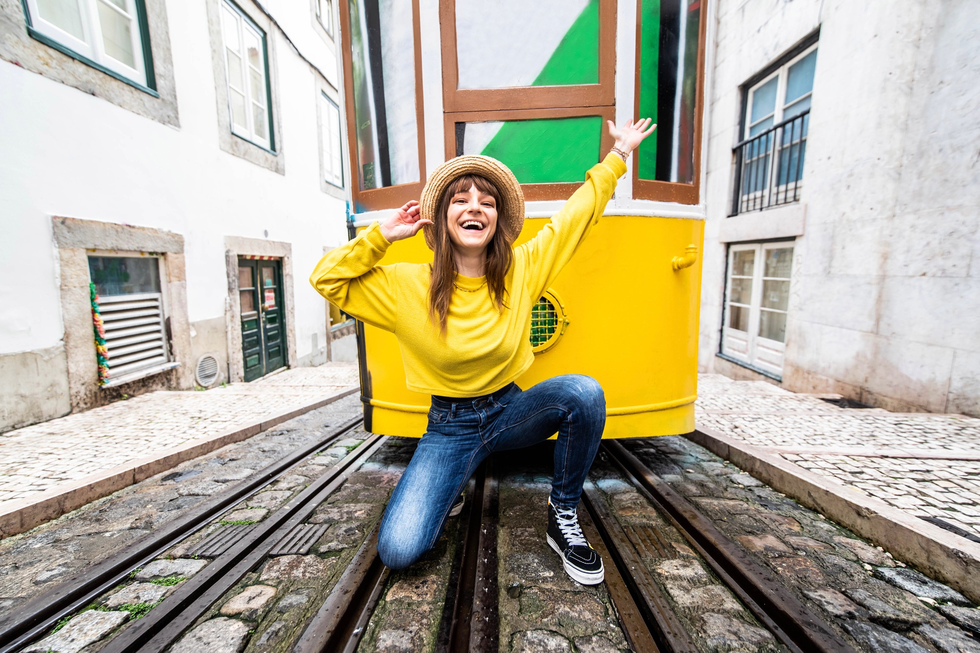 Woman tourist with famous yellow funicular tram of Lisbon, Portugal